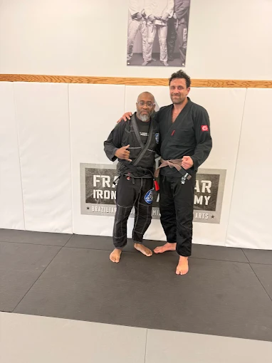 Frankie Edgar and a black belt coach on the academy mats