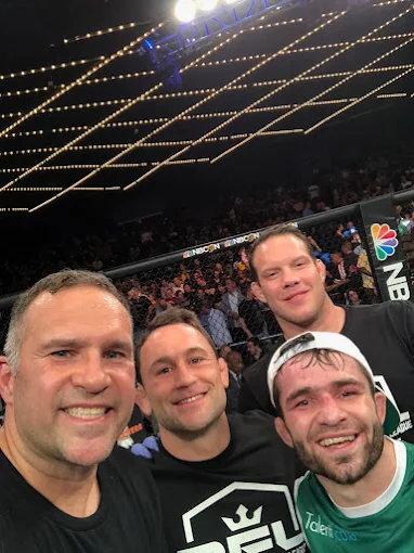 Frankie Edgar with friends cageside at a fight